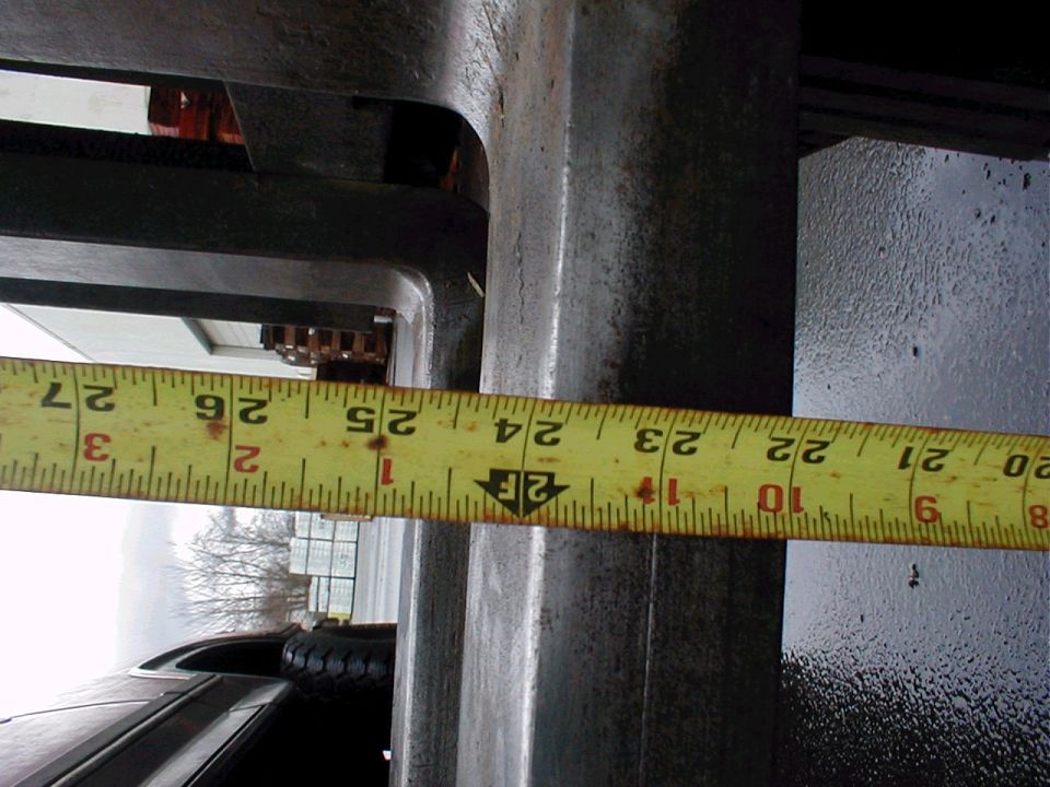 Measuring tape showing 24 inches on a metal frame