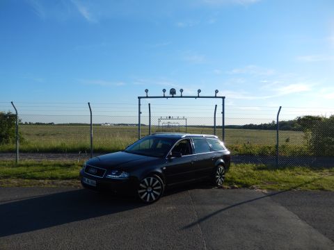 2003 Audi A6 - A black Audi A6 Avant is parked near a fence under a clear blue sky.