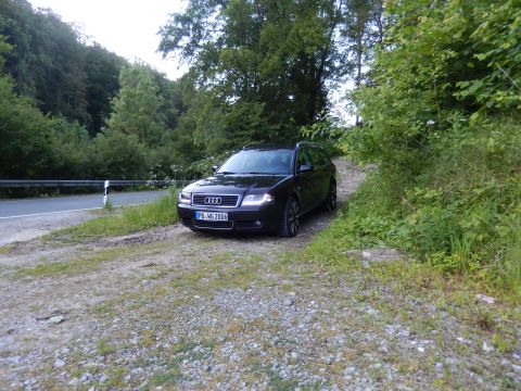 2003 Audi A6 - A black Audi wagon is parked on a dirt road surrounded by trees, with its license plate visible.
