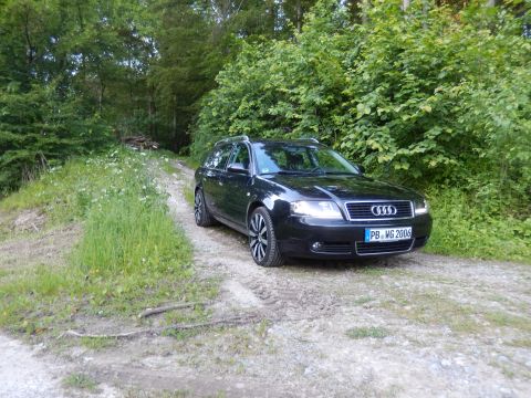 2003 Audi A6 - A black 2003 Audi A6 Avant is parked on a dirt road surrounded by trees.