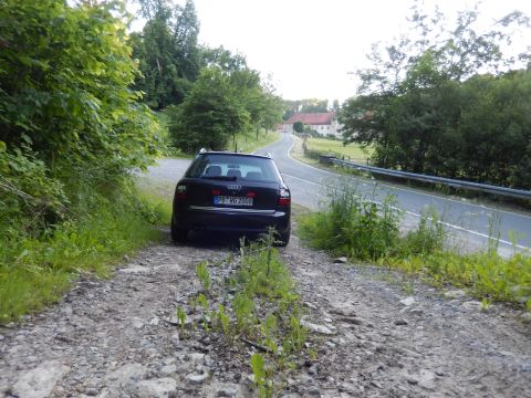 2003 Audi A6 - A dark Audi wagon is parked on a gravel path beside a country road, with a license plate reading PB-WG 2006.