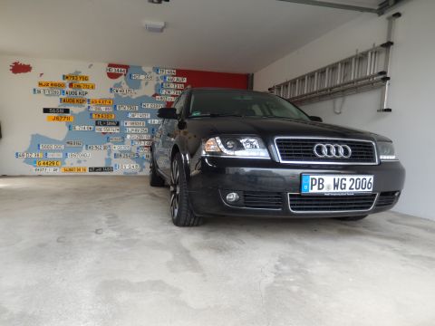 2003 Audi A6 - Black 2003 Audi A6 sedan parked in a garage with a map of Europe decorated with license plates on the wall.