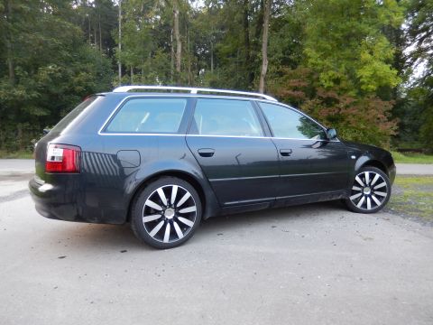 2003 Audi A6 - The side profile of a dark grey Audi A6 Avant is shown parked outdoors.