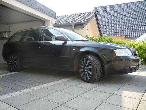 2010 Audi A4 - A black station wagon is parked in a driveway with a garage in the background.