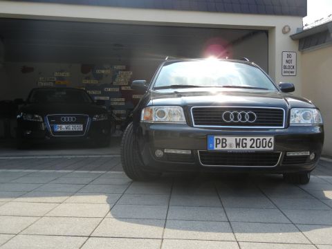 2010 Audi A4 - Two Audi sedans, a 2006 A6 and a 2010 A4, are parked side-by-side in a garage.