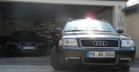 2010 Audi A4 - Two Audi sedans are parked in a garage, one with license plate PB WG 2006 and the other with PB WG 2010.