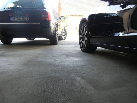 2010 Audi A4 - The rear of a black Audi A6 wagon is visible, showing its license plate and chrome trim.