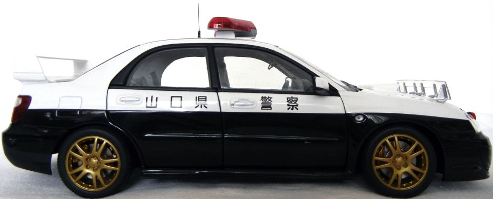Subaru Impreza Japanese police car model with gold wheels and roof light