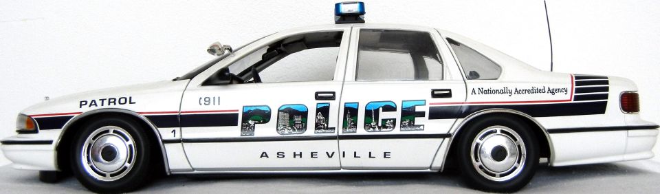 White police car model with "PATROL" and "POLICE" text, "Asheville" on the side