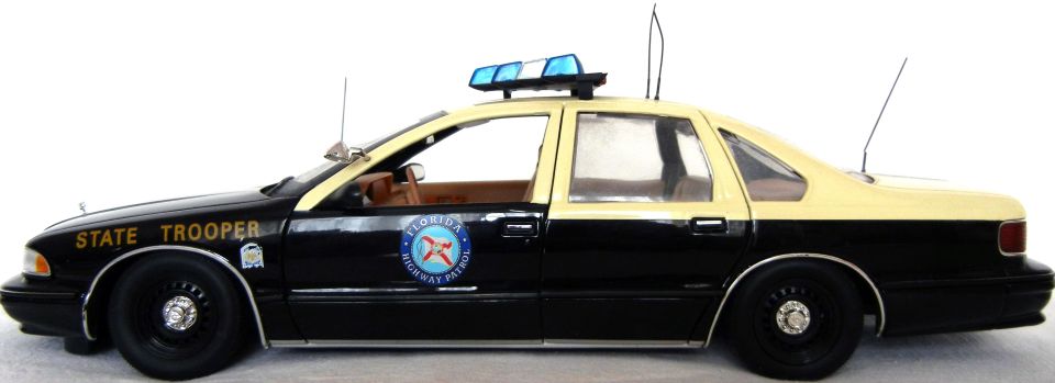 Black and tan die-cast police car with 'STATE TROOPER' text and Florida Highway Patrol emblem