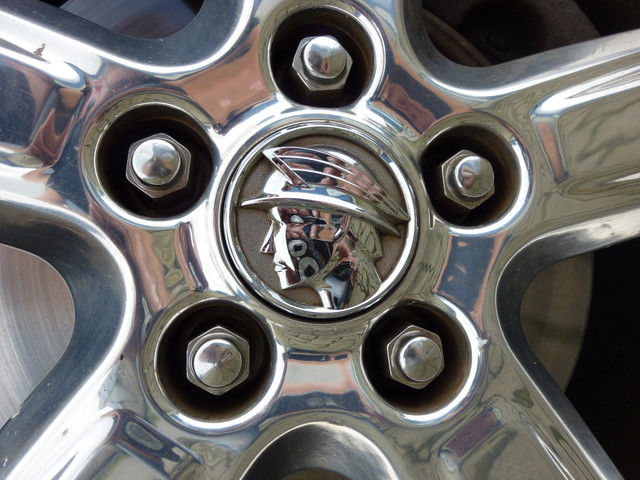 Close-up of a chrome wheel with a Mercury emblem a profile of the Roman god Mercury