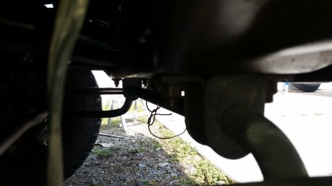 1991 Ford F-250 - Close-up view of the undercarriage, showing suspension parts and a tire. The registry information may be inaccurate.