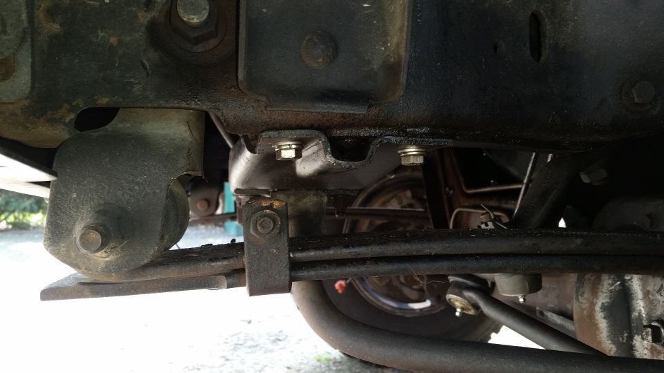 Close-up of truck's leaf spring, shackle, and frame bracket
