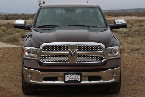 2015 Dodge 1500 - Front view of a maroon Dodge Ram pickup truck with a prominent chrome grille and bumper.