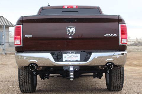 2015 Dodge 1500 - Rear view of a brown 2015 Dodge 1500 pickup truck, a chrome bumper, dual exhaust pipes, and a Ram logo.