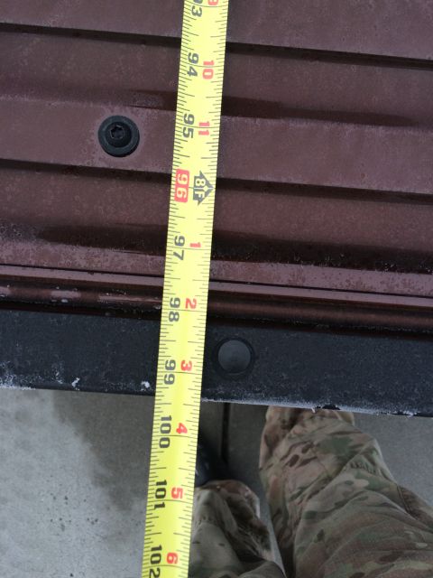 2015 Dodge 1500 - A tape measure is shown against the side of a truck bed, indicating length.