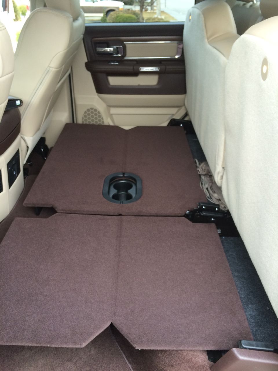 Interior rear floor with folded seats and cup holder