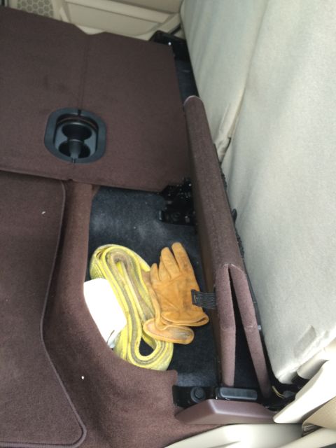 2015 Dodge 1500 - Interior storage compartment holds a tow strap and gloves.