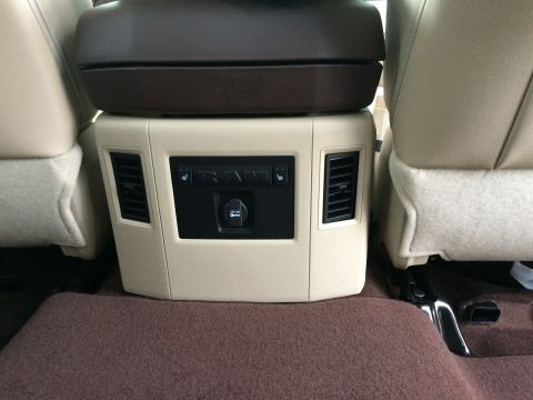2015 Dodge 1500 - Interior view of the rear seat console in a 2015 Dodge 1500, showing climate controls and a power outlet.