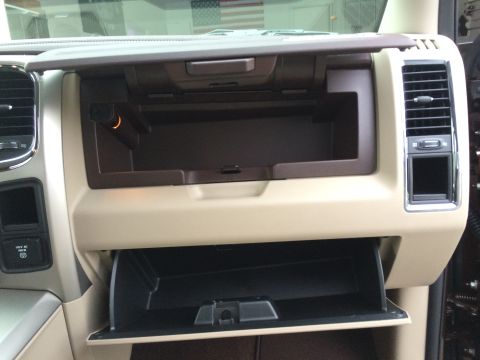 2015 Dodge 1500 - The dual glove compartments of a 2015 Dodge 1500 are shown open, revealing their storage capacity.