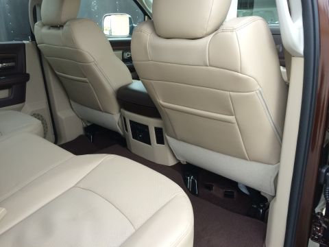 2015 Dodge 1500 - Rear interior view of a 2015 Dodge 1500, highlighting the beige leather seats and console area.