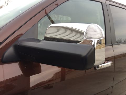 2015 Dodge 1500 - Close-up of a truck's side mirror assembly, showing chrome accents and a turn signal light.