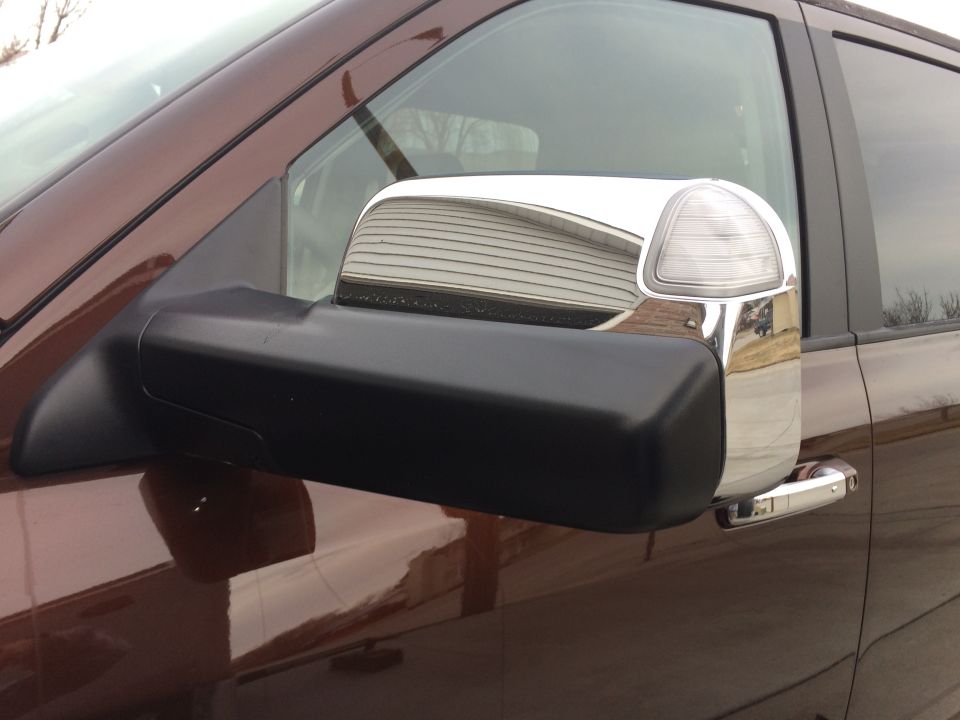 Truck's side mirror with chrome trim and turn signal indicator