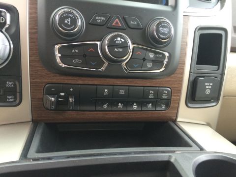 2015 Dodge 1500 - Interior view of a 2015 Dodge 1500 showing the center console with climate controls and a 115V AC outlet.