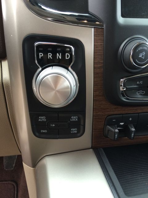 2015 Dodge 1500 - The interior of a 2015 Dodge 1500 features a rotary gear shifter and selectable 4WD controls.