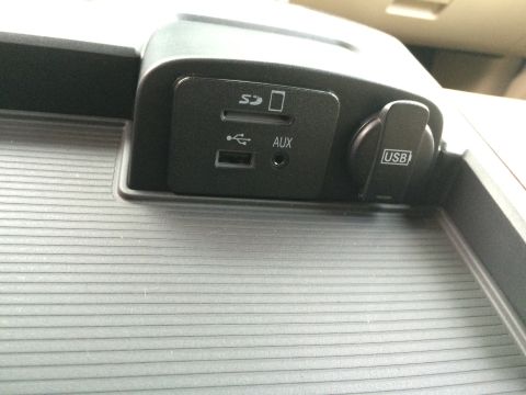 2015 Dodge 1500 - Close-up of the center console showing various ports including USB, AUX, and an SD card slot.