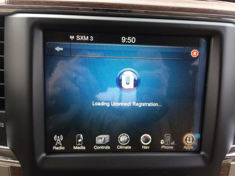 2015 Dodge 1500 - The vehicle's infotainment system is shown displaying a Uconnect loading screen.