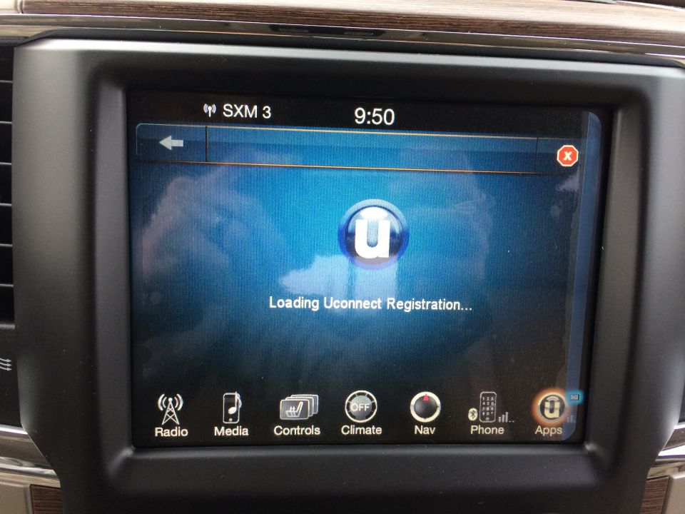 Infotainment screen displaying Uconnect loading screen with icons for Radio, Media, Controls, Climate, Nav, Phone, and Apps