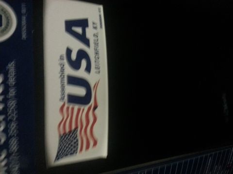 1994 Ford Bronco - Photo of an Assembled-in-USA product label with a flag, not a classifiable technical document.