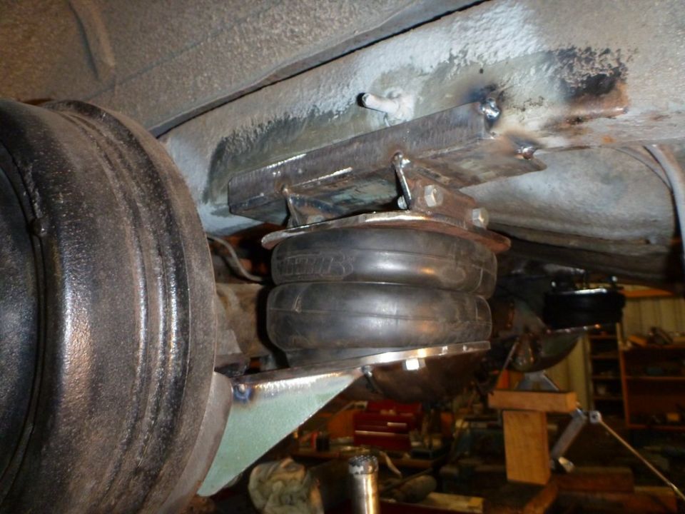 Air suspension bellows and mounting hardware under vehicle