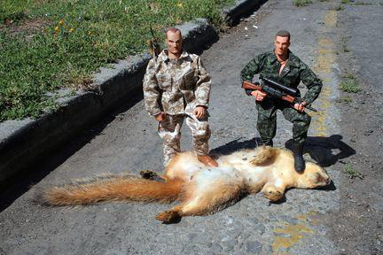 1973 Ford Ranchero - Toy soldiers pose with a dead squirrel on a road, suggesting a staged hunting scene.