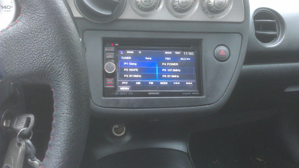Car interior with Kenwood stereo displaying radio presets