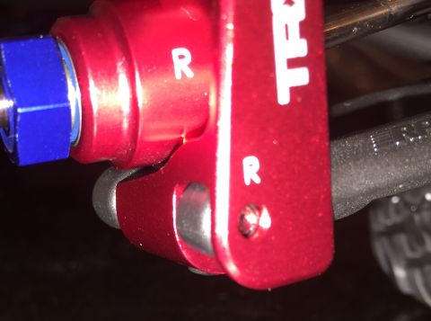 2014 Dodge 1500 - A close-up view of a red component with 'R' markings and a blue nut, likely a vehicle part.