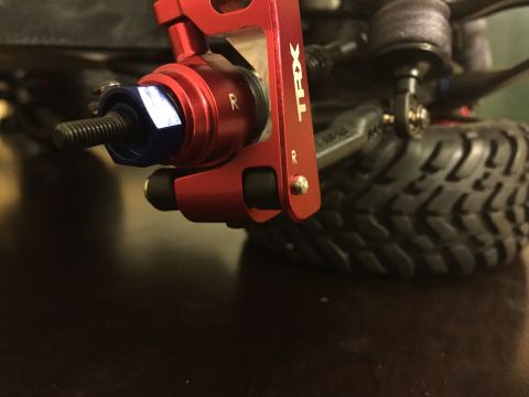 2014 Dodge 1500 - Close-up of a red TRX suspension part with visible text and a threaded bolt.