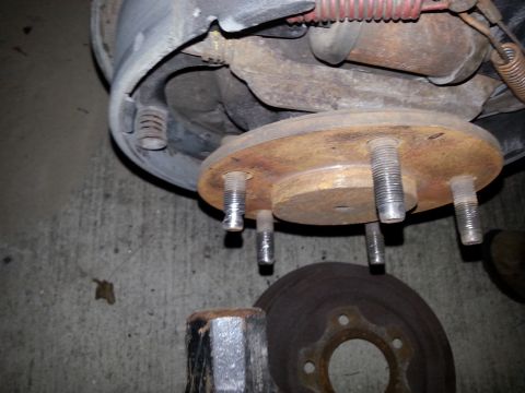 1992 Ford Bronco - This photo shows a close-up of a vehicle's wheel hub assembly, likely during a brake or wheel stud repair.