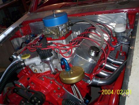 1963 Ford Falcon - Custom engine bay features a bright red engine block, a blue air filter, and polished chrome headers, with a date stamp of 2004.