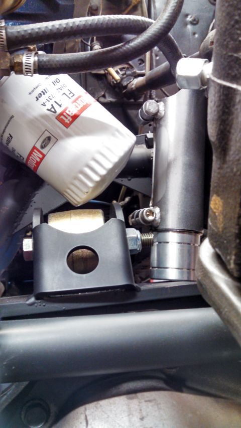1967 Ford F-250 - Close-up view of engine components, including an oil filter and hoses.