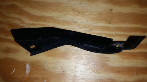 2015 Chevrolet new - A black plastic automotive trim piece is shown against a wooden background, with a SuperMotors watermark.