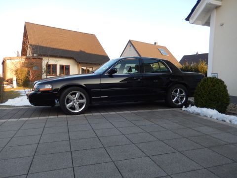 2003 Mercury Marauder - A black 2003 Mercury Marauder is parked on a tiled driveway next to a house with snow on the ground.