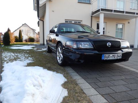 2003 Mercury Marauder - A black 2003 Mercury Marauder is parked in front of a modern house on a partly snowy day.