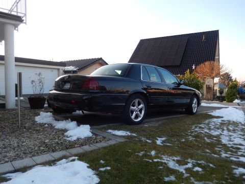 2003 Mercury Marauder - A black 2003 Mercury Marauder is parked in a residential driveway during winter.