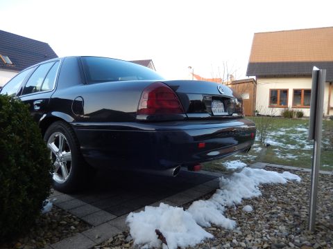 2003 Mercury Marauder - Rear view of a 2003 Mercury Marauder parked on a driveway with snow on the ground.