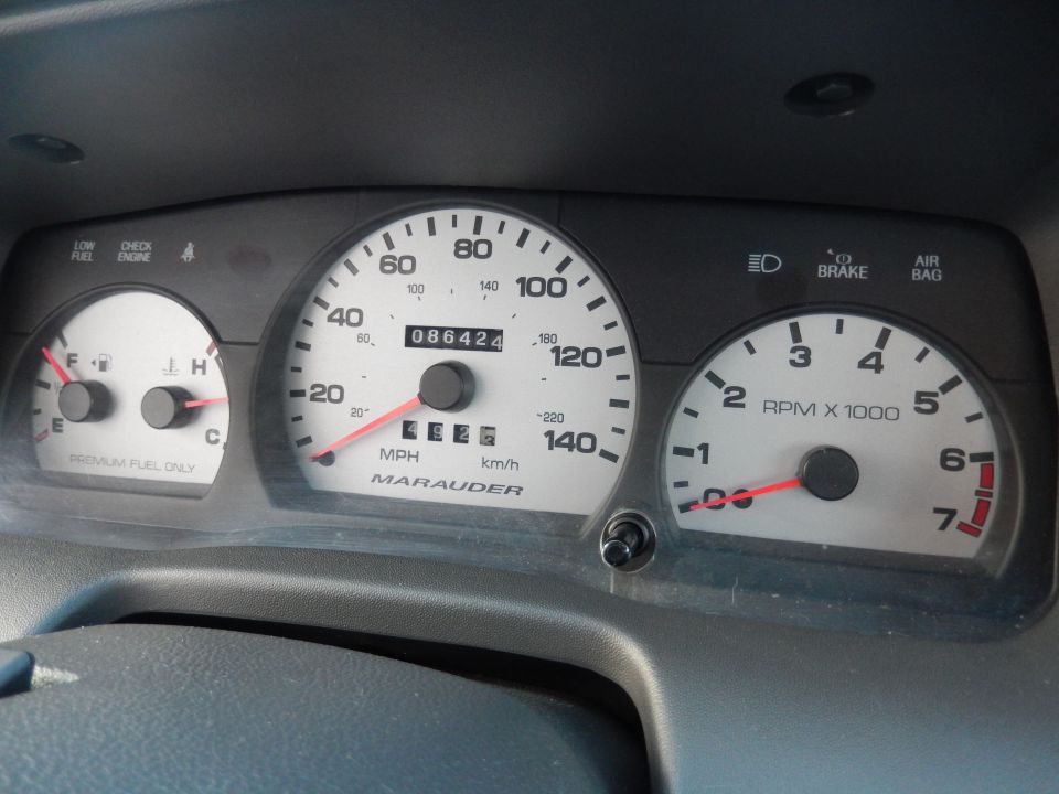 Dashboard gauges with 'Marauder' text on speedometer, fuel gauge, and tachometer