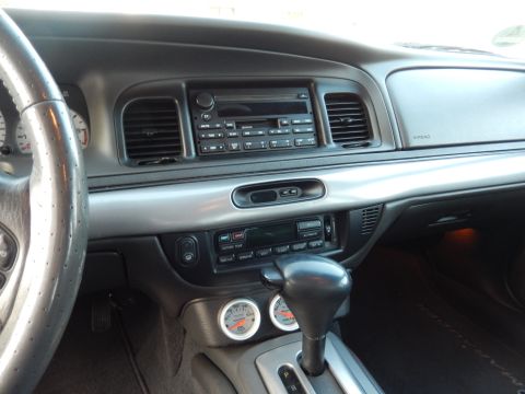 2003 Mercury Marauder - Interior view of a 2003 Mercury Marauder, showing the dashboard, steering wheel, and center console with aftermarket gauges.