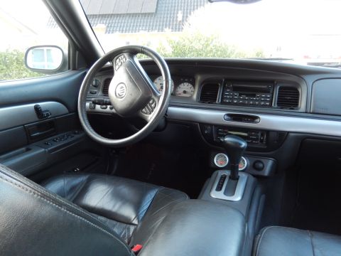 2003 Mercury Marauder - The interior of a 2003 Mercury Marauder shows black leather seats, a steering wheel with the Mercury logo, and a dashboard with gauges and…