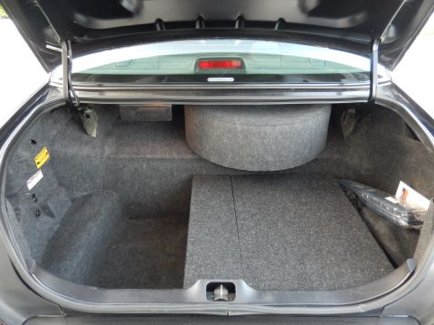 2003 Mercury Marauder - The trunk of a car is shown with a spare tire and custom carpeting.
